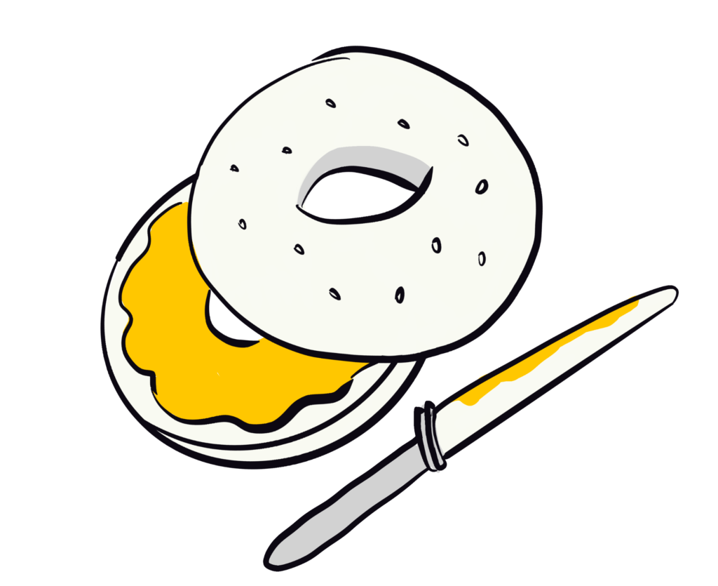 A split bagel with one half spread with a yellow substance, and a knife next to it.